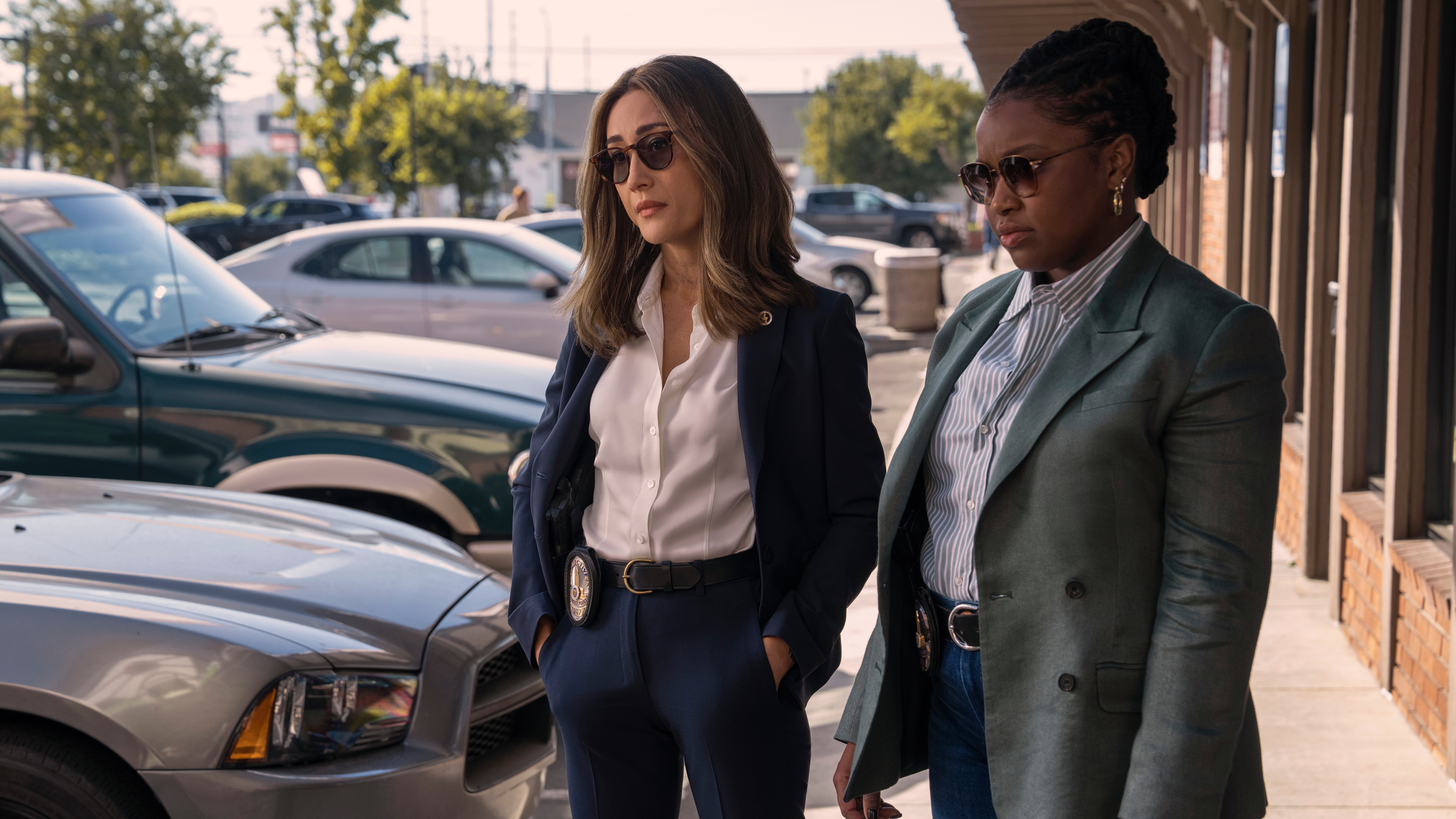 L-R: Renee Ballard (Maggie Q) and Zamira Parker (Courtney Taylor) standing in a parking lot in a scene from Prime Video's "Ballard"