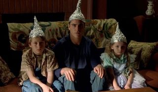 Joaquin Phoenix, Rory Culkin, Abigail Breslin wearing tin hats