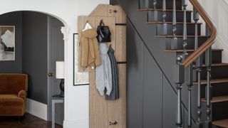 painted staircase in grey with wooden bannister and treads and built in storage below
