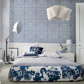 bedroom with blue wallpaper and carpet flooring