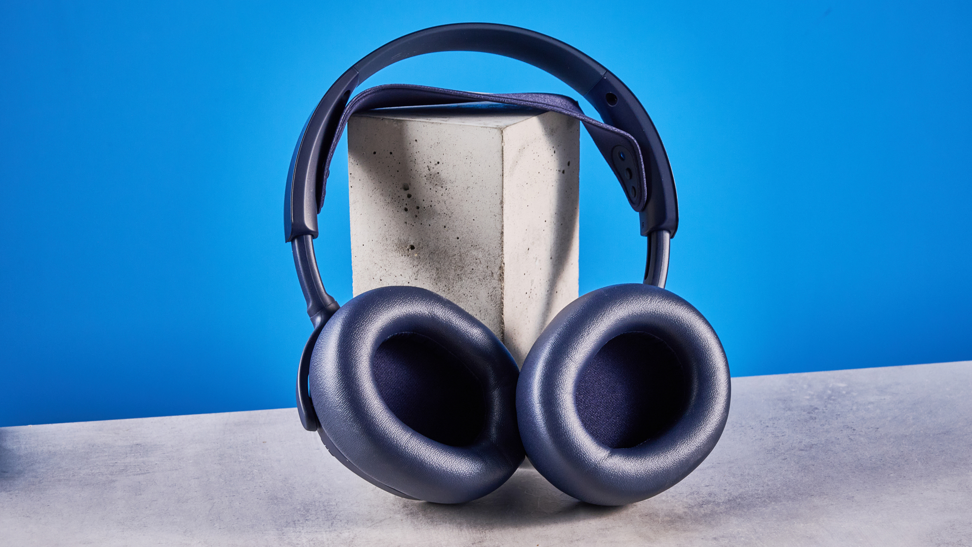 The SteelSeries Arctis Nova Pro Omni on a stone surface against a blue background