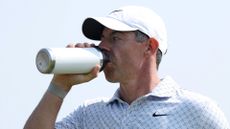 Rory McIlroy drinking from a water bottle