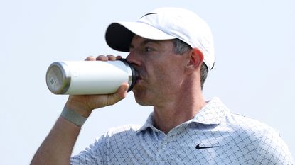 Rory McIlroy drinking from a water bottle