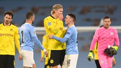 Erling Haaland speaks with Phil Foden after the Champions League clash at the Etihad 