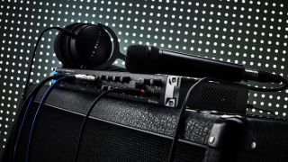 An audio interface sitting on top of a guitar cabinet