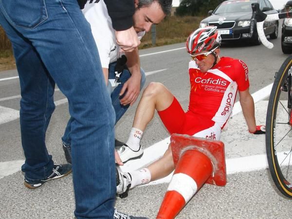 A Cofidis rider receives attention after hitting the deck.