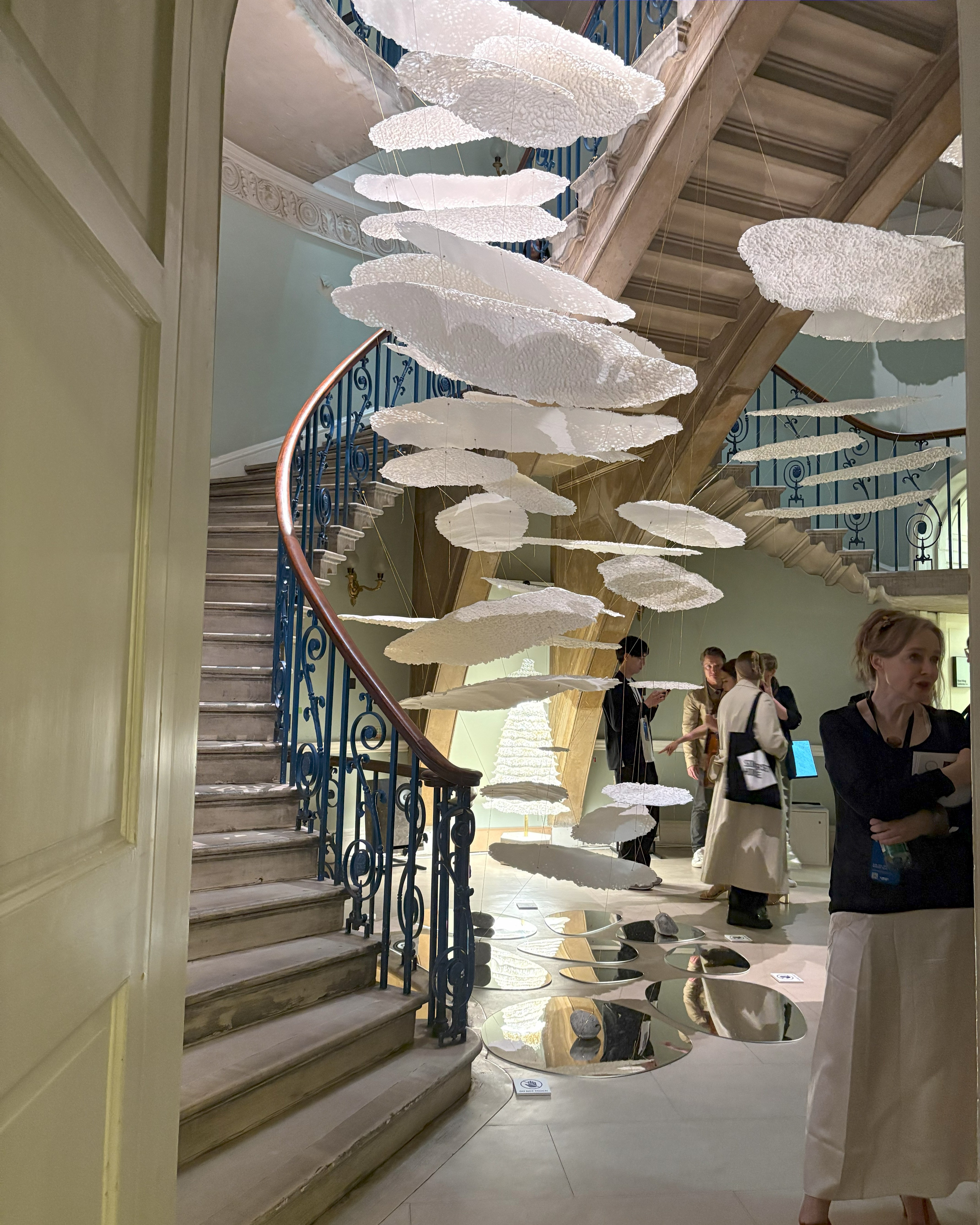 A design installation features paper-thin, floating installations, placed within a staircase of a historical palace.