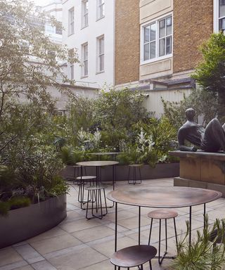 Hermès garden terrace with table for dining and plants