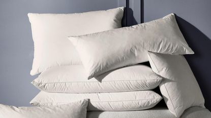 Pillow sizes explained: Lots of different size pillows in a pile 