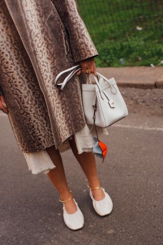 woman wearing leopard print coat, dress, and ballet flats