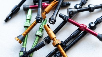 A selection of the best tubeless valves places on a workbench