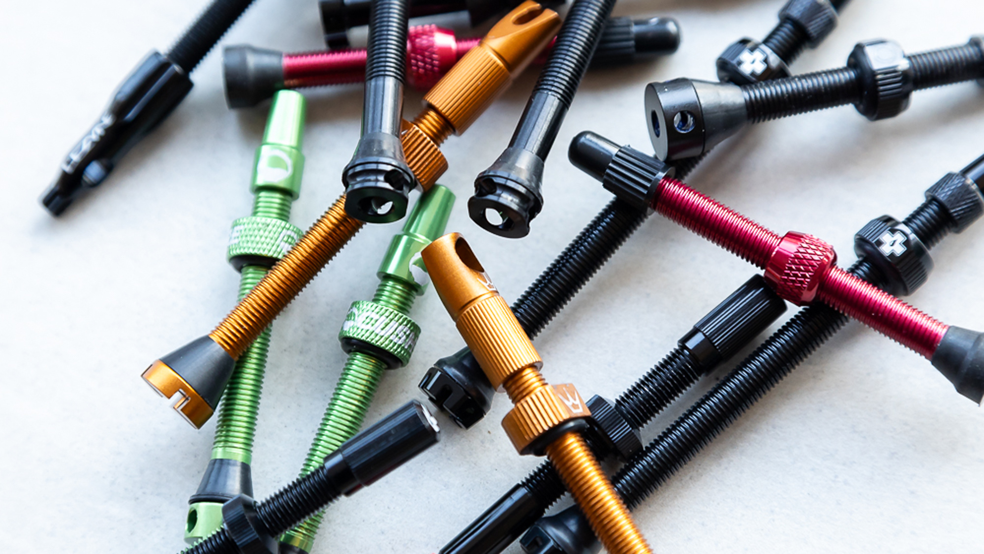 A selection of the best tubeless valves places on a workbench