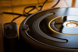 The Roomba 650 sits steadily at its charging base.