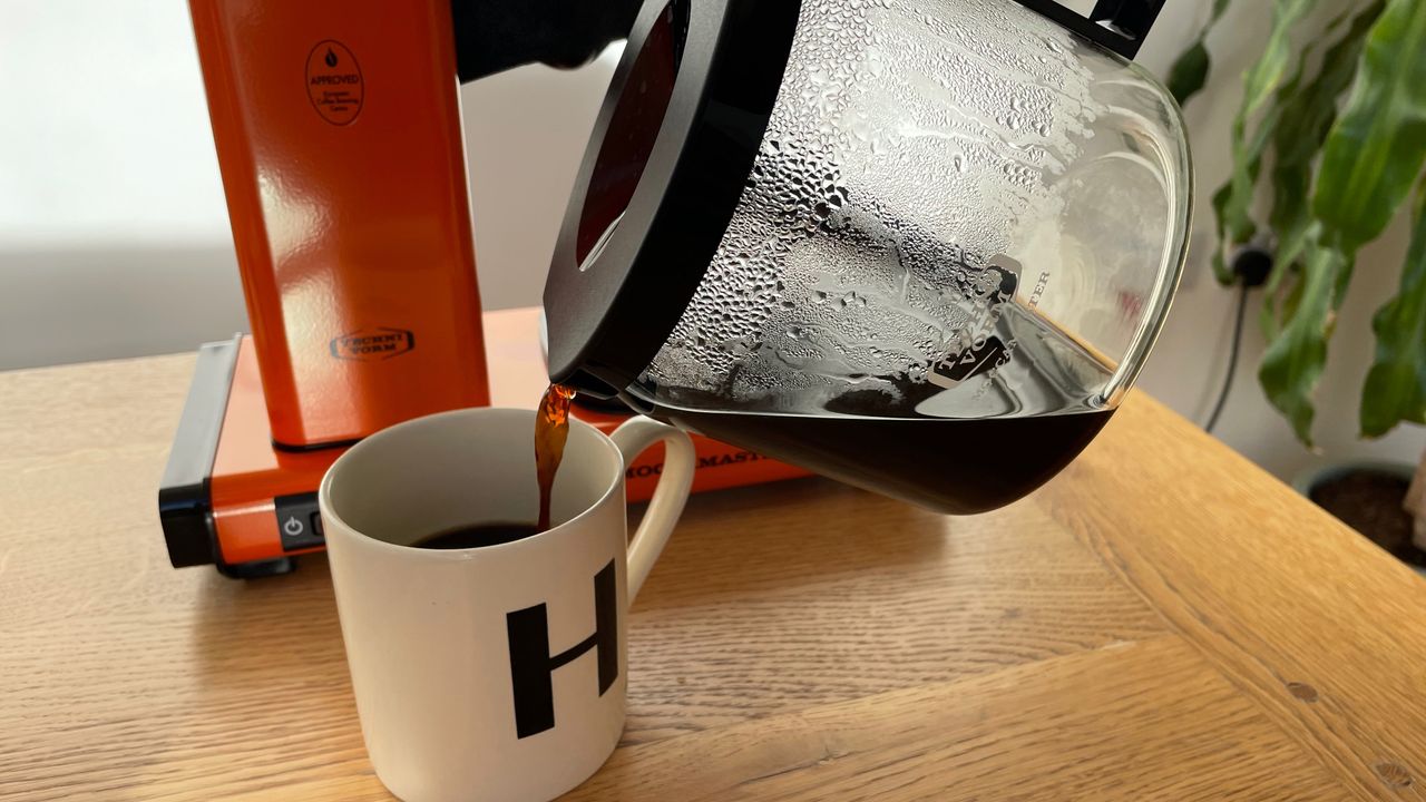 Pouring coffee into a mug from the Moccamaster