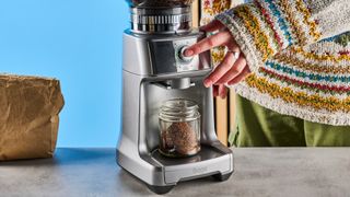 the breville dose control pro, called sage dose control pro in the uk, a silver coffee grinder with 60 grind settings and labeled grind size adjustment