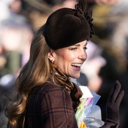Kate Middleton wearing a plaid coat and brown hat on Christmas Day in Sandringham 2025