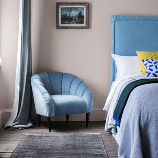 Armchair in teal velvet in a bedroom