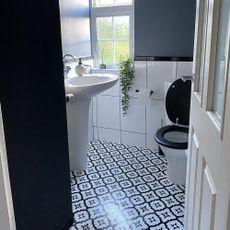 bathroom with patterned tiles and white sink