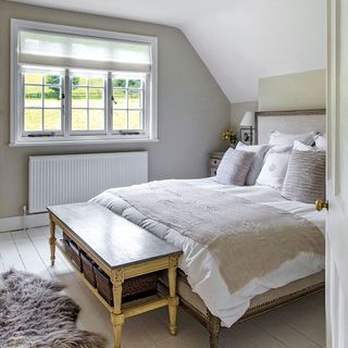 bedroom with white and grey wall and white tiles on floor
