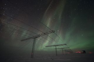 Wispy, green auroras shimmer over Antarctica in this photo captured from the Amundsen-Scott South Pole Station, a research site operated by the National Science Foundation.