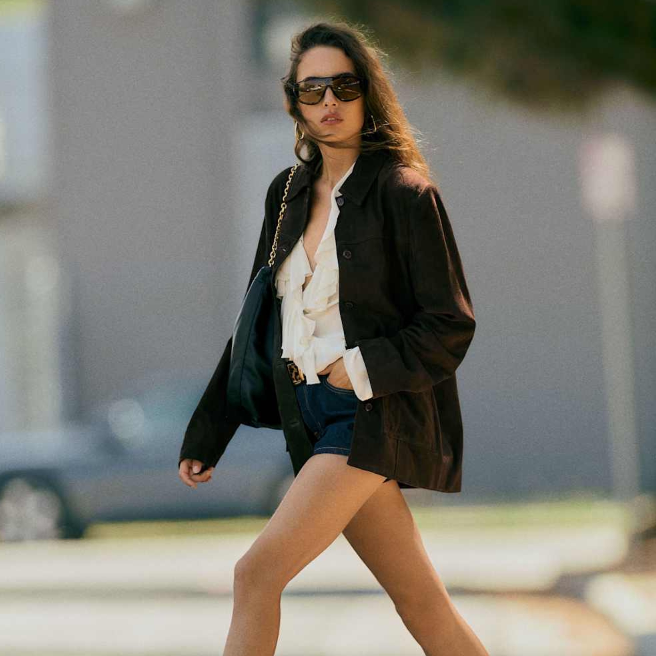 Model wearing a brown suede jacket look from Reformation. 