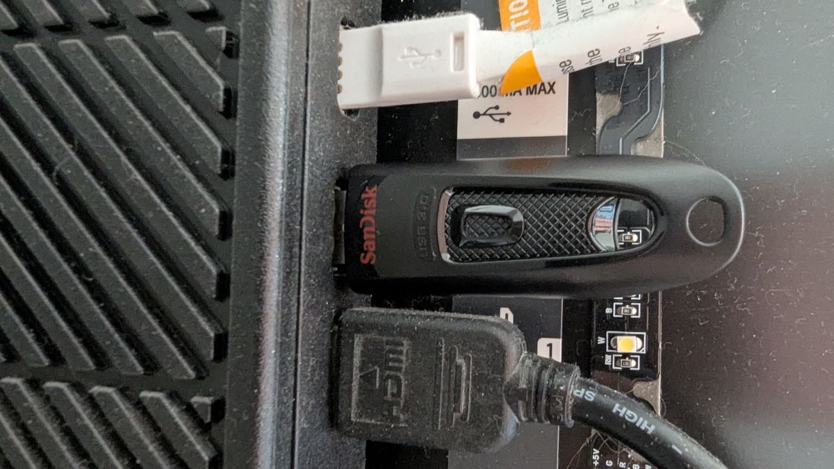 A USB stick plugged into the USB port around the back of a smart TV