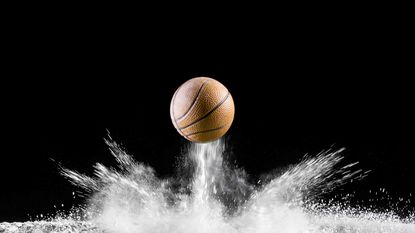 A basketball bounces off the ground