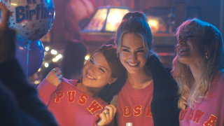 Catherine Missal, Grace Van Patten, and Sonia Mena as Bree, Lucy, and Pippa in Tell Me Lies season 2, holding up their PUWAS jumpers