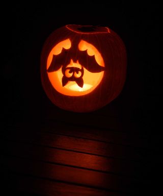 bat design carved into halloween pumpkin