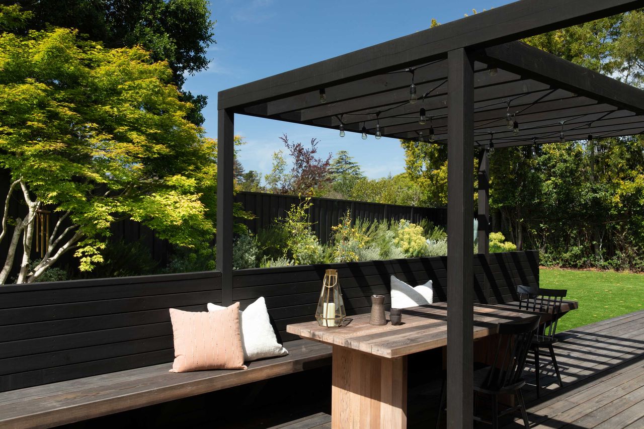 a backyard seating area screened by trees