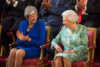 Theresa May and the Queen sat next to each other