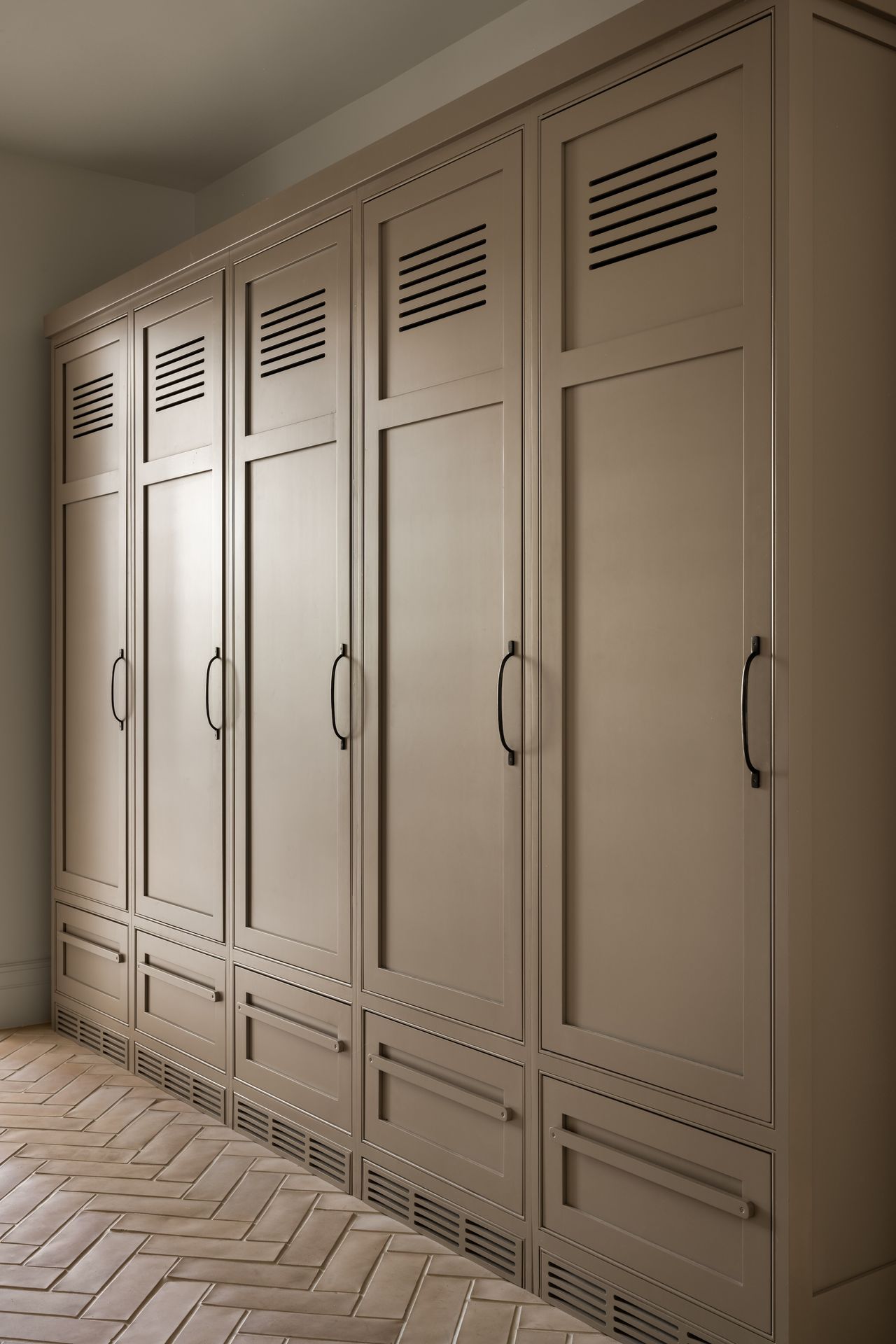 A neutral-panted row of wooden lockers