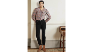 a model wearing a Boden floral blouse with black jeans