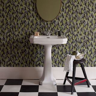 bathroom with washbasin and motif wallpaper