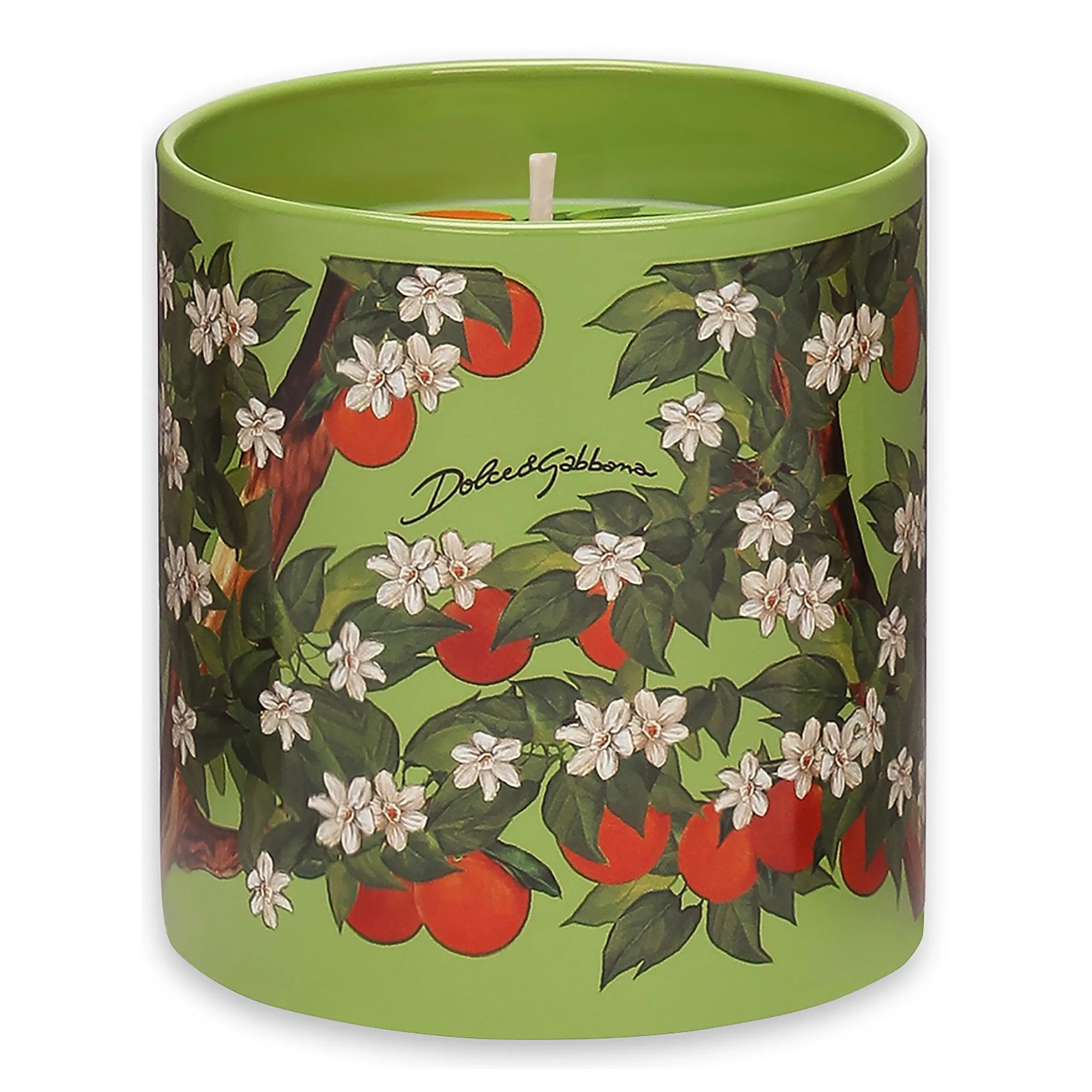 A green candle with patterns of leaves, oranges and jasmine flowers.