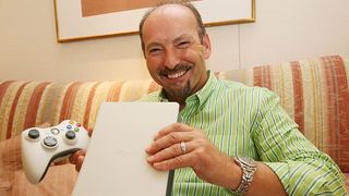 Peter Moore, Vice President of Microsoft Corporation shows the Xbox 360 game console.