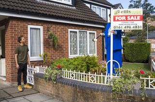 David examines the 'For Sale' sign.