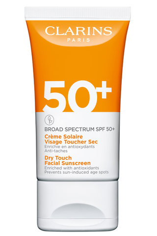 Clarins sunscreen bottle on a white background