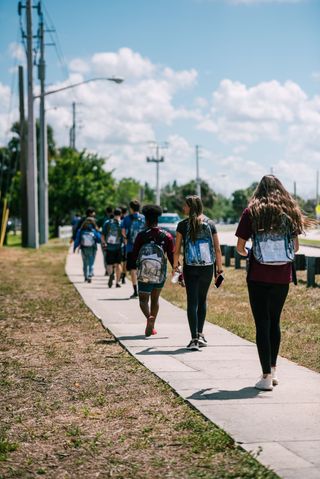 Students walk home from school with their clear backpacks April 2018.