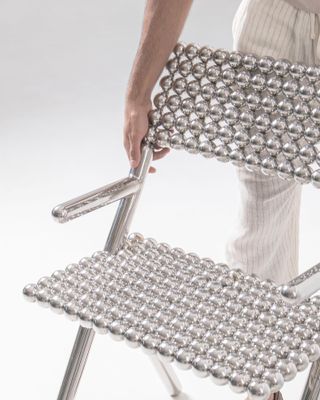 Chair made of metal spheres, example of metal furniture