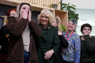 Queen Camilla standing with a group of women at a Sexual Assault Referral Centre in February 2025