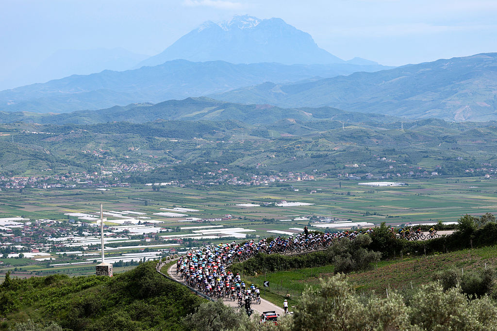 The pack rides in an ascent during the first stage of the 108th Giro d'Italia cycling race, 160km from Durres to Tirana in Albania, on May 9, 2025. (Photo by Luca Bettini / AFP)
