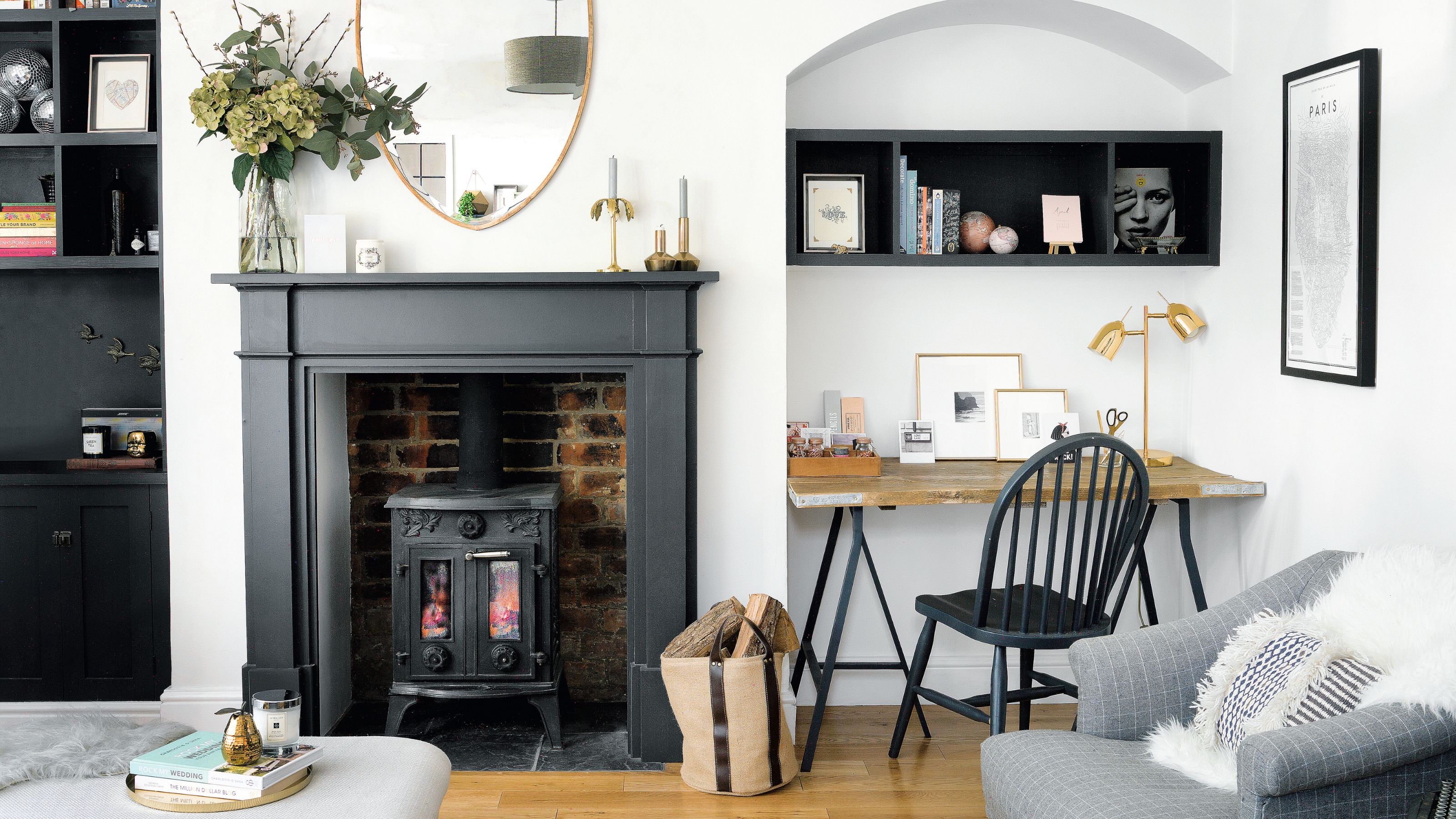 White living room with black fireplace surround and a log burner