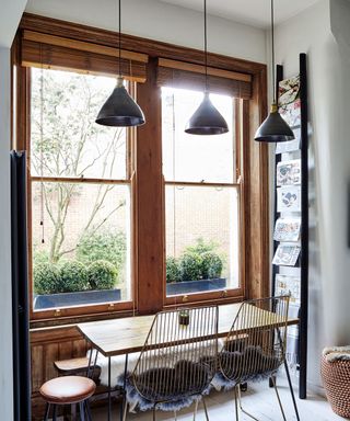 Dinning table and chair facing sash wooden window frame