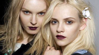 two sulky looking models with goth makeup