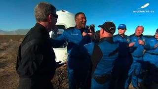 Good Morning America co-anchor and NFL star Michael Strahan receives his Blue Origin astronaut wings from founder Jeff Bezos after launching on the New Shepard NS-19 suborbital flight on Dec. 11, 2021 from the company's Launch Site One near Van Horn, Texas.