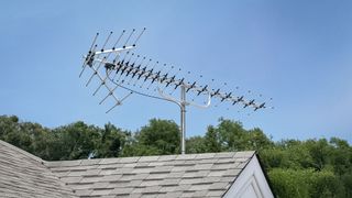 Antennas Direct Goliath TV antenna on the roof of a house.