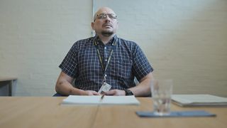 Martin, one of the subjects of Parole season 2, sitting at a table during his parole hearing.