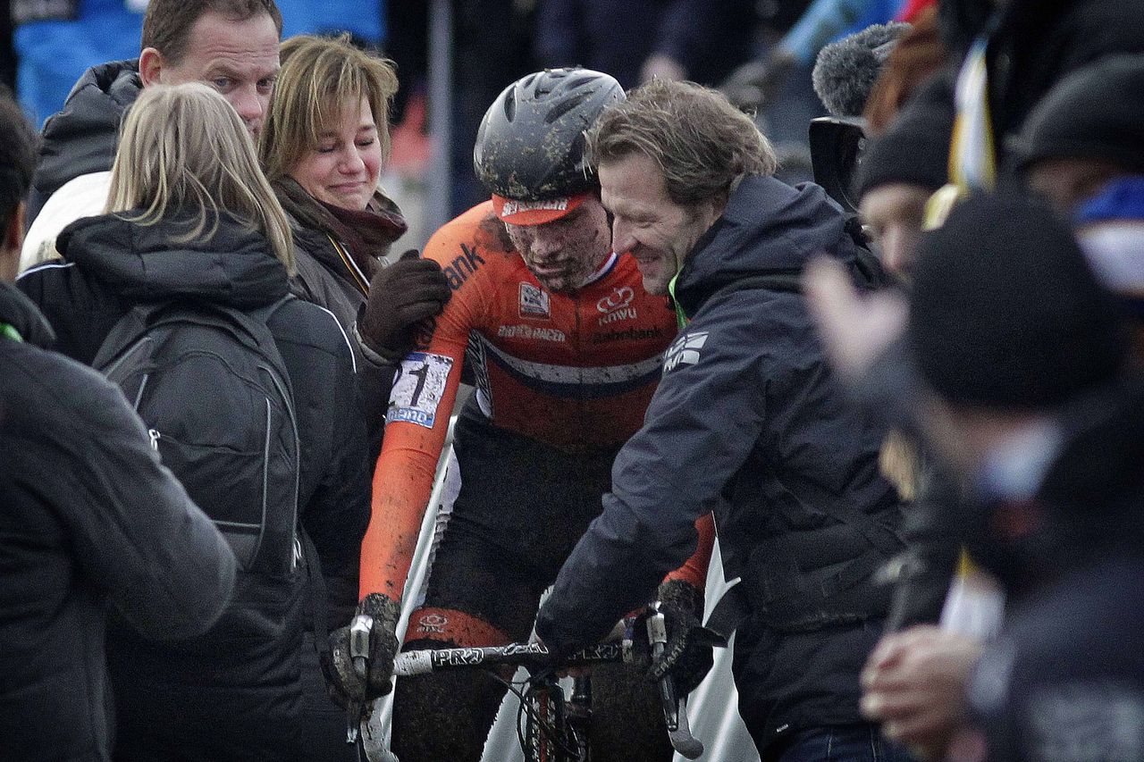 Mathieu van der Poel is shepherded towards the podium after winning the world cyclo-cross title.