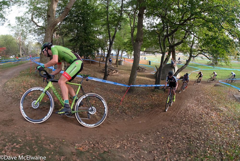 Curtis White (Cannondale) leading a group of six through the wooded section of the course